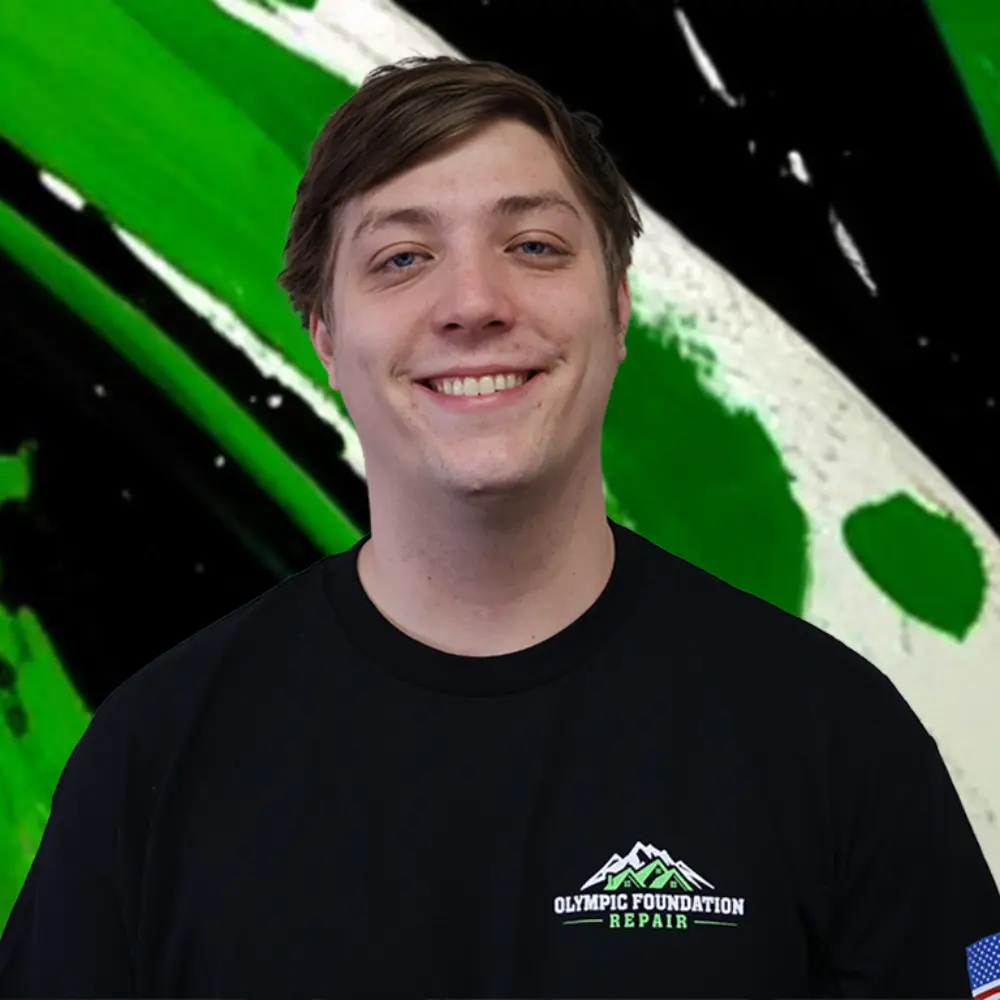 Smiling man in a black shirt with the Olympic Foundation Repair logo, posed against a green and black abstract background.